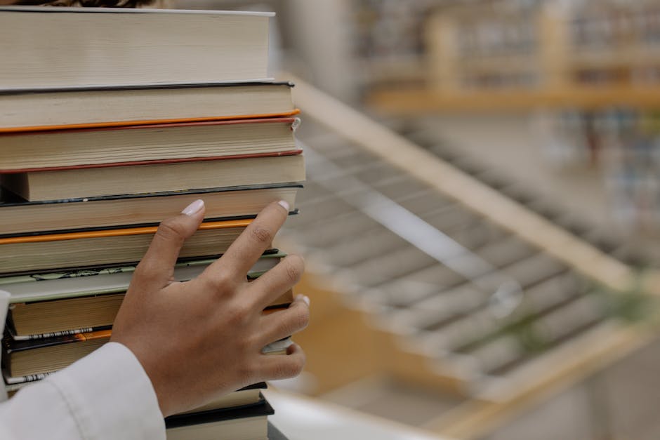 Stack of books on probabilistic thinking and decision theory arranged on a desk with a notebook and pen.