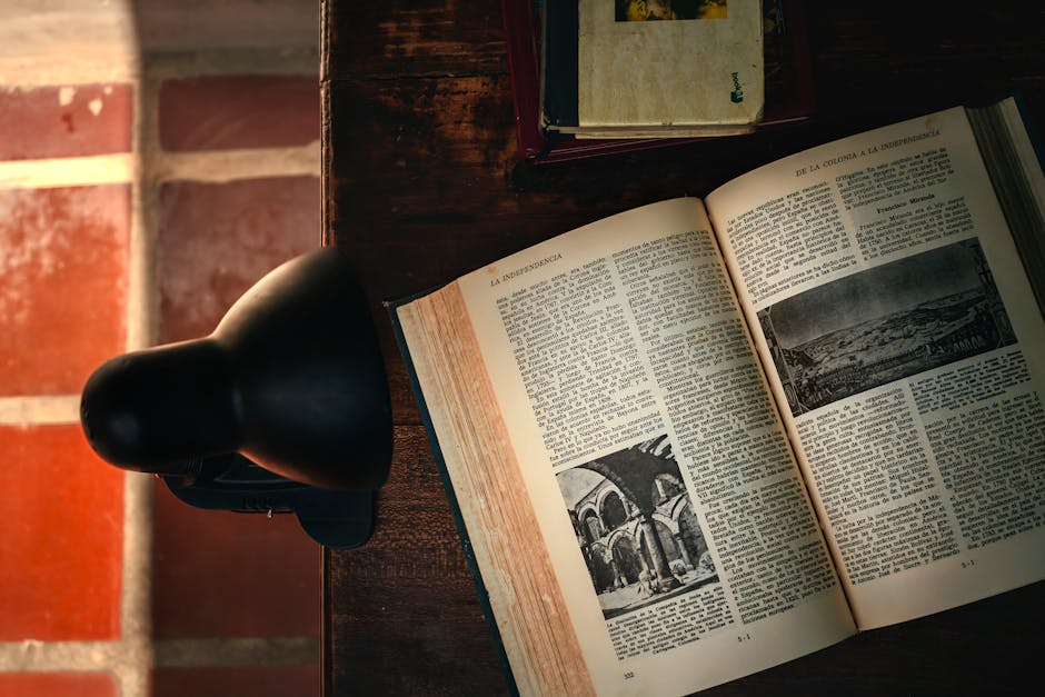 Open decision-making books on a wooden desk under warm light