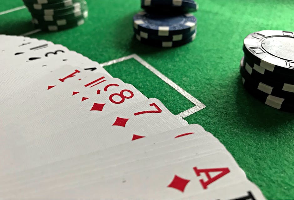 Poker chips and playing cards on a green felt table — calculating expected value at the felt