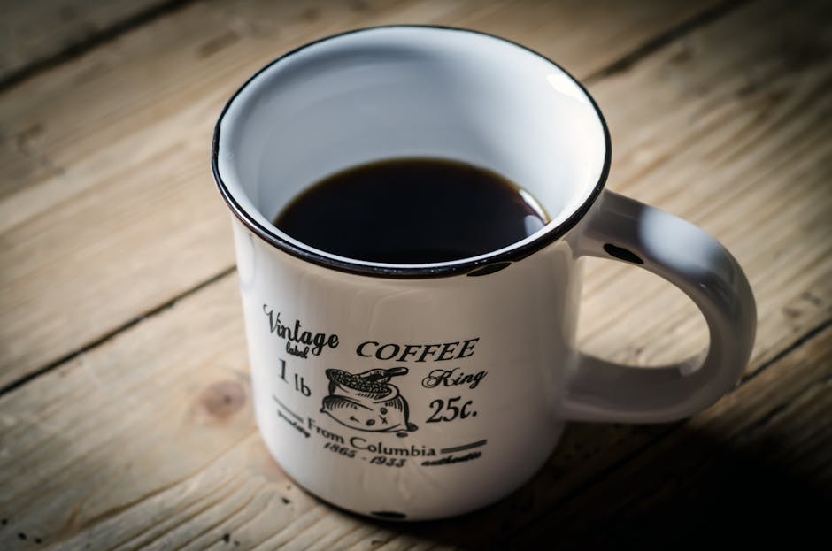 Vintage ceramic coffee mug on a wooden table, the prop used in Richard Thaler's famous endowment effect experiments at Cornell.